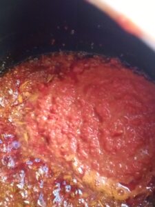 picture of red oil, onions and tatashi in a pot