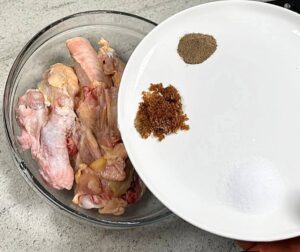 picture of seasoning been added to the chicken for sweet chicken combo